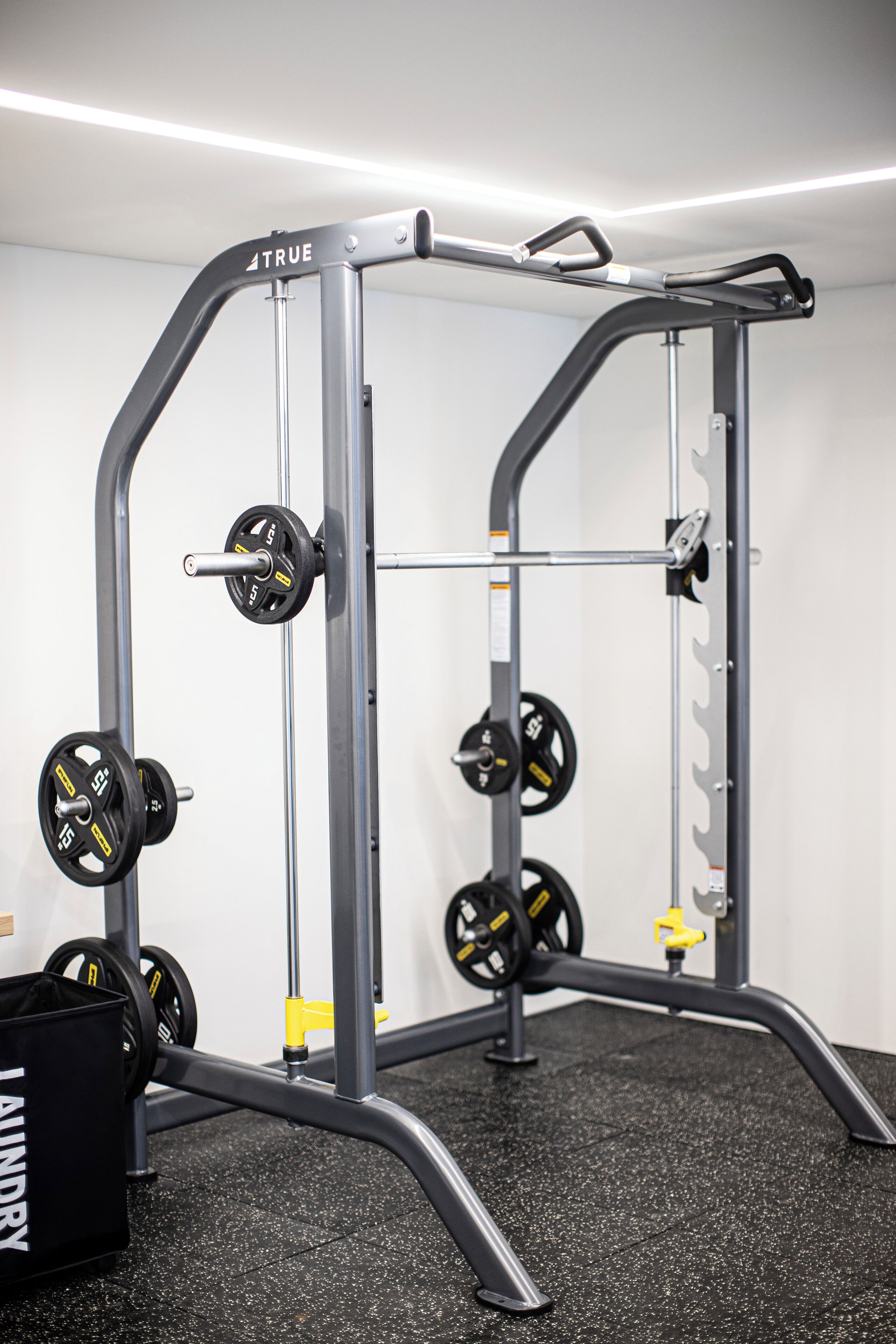 A weightlifting station with adjustable bars and weight plates.