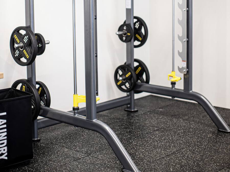 A weightlifting station with adjustable bars and weight plates.