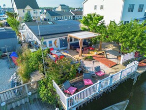 Terrace/patio - Minutes to Ocean! 3-bedroom waterfront Boho Beach Bungalow with AC,WIFI,Bar Shed (Stafford Township)