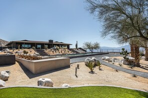 A modern house with a patio, desert plants, and a view of the sea. - Addendum Estate - 2 Pools, Panoramic Views & Luxe Privacy for Groups (Desert Hot Springs)