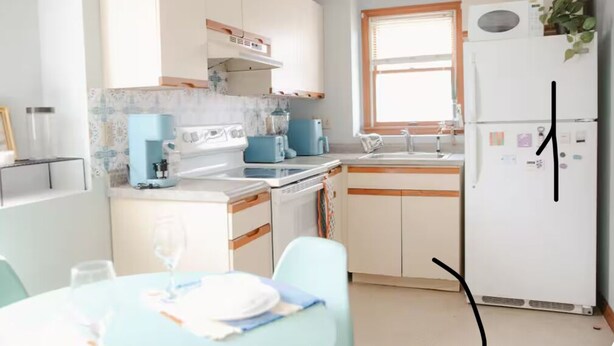 A modern kitchen with white cabinets, a blue countertop, and a refrigerator. - The Retro Apartment in Revere with outdoor area (Revere)