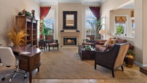 A spacious living room with a fireplace, leather furniture, and large windows. - Spacious w/ Yard, BBQ, Presidio Access Near Park, Pool, Tennis, Beaches & Legoland! Extended Stays (Carlsbad)