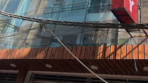 A modern building with a glass facade and a prominent red sign that reads "Fly." - Hotel Aero Fly (New Delhi)