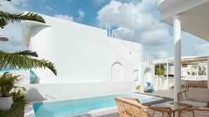 A pool area with a white building, outdoor seating, and a staircase leading to an upper level. - BanyakasSirindhron (Sirindhorn)