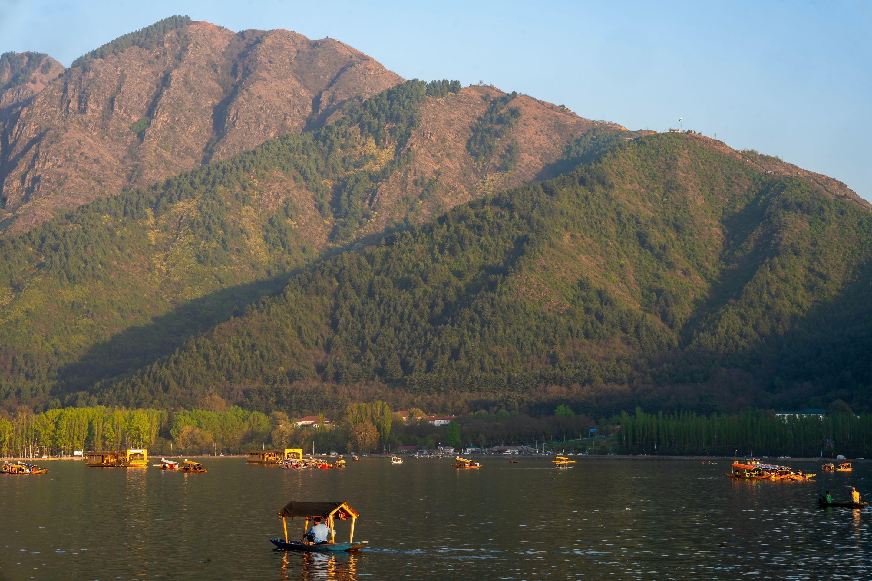 A lake with boats and a wooden structure on the water.