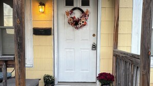A wooden porch with a white door, a number '5' sign, a wreath, and three pumpkins. - 2-bedroom guest house in charming Cuba with WiFi (Cuba)