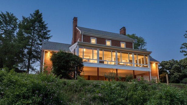 A two-story house with a large balcony and a well-lit interior. - Stay 3 and play 4 free!!! (Dandridge)