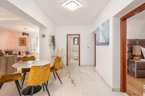A modern interior with a dining area, a living room, and a hallway leading to a bathroom. - Villa Natali With Pool And Sea View (Kraljevica)