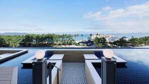A pool area with steps leading to a seating area, overlooking a coastal view. - Fukuoka Prince Hotel Momochihama (Fukuoka)