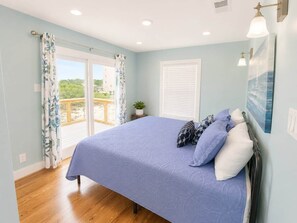 A bedroom with a bed, curtains, a window, and a view of the outdoors. - "Shady Pines"- You will have a Golden Time! (Gulf Shores)