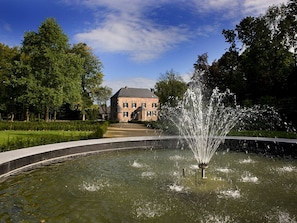 Stroll through the serene garden, surrounded by a tranquil water feature and lush greenery.