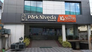 A modern building with the sign 'Park Niveda' indicating a hotel. - Park Niveda (Vijayawada)
