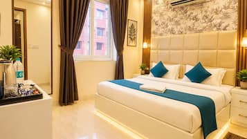 A modern hotel room with a bed, bedside tables, a ceiling fan, and a window with curtains.