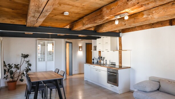 A modern kitchen with white cabinets, a wooden countertop, and a built-in oven. - Apartment 'Steigen' with Wi-Fi (Heiligenberg)
