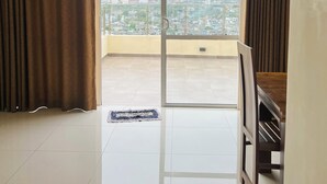 Een ruime woonkamer met een grote schuifdeur naar een balkon.