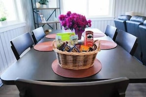 Enjoy meals in this dining area with a table for four, complete with a wicker basket and comfortable seating.