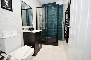 Shower, hair dryer, towels, shampoo
