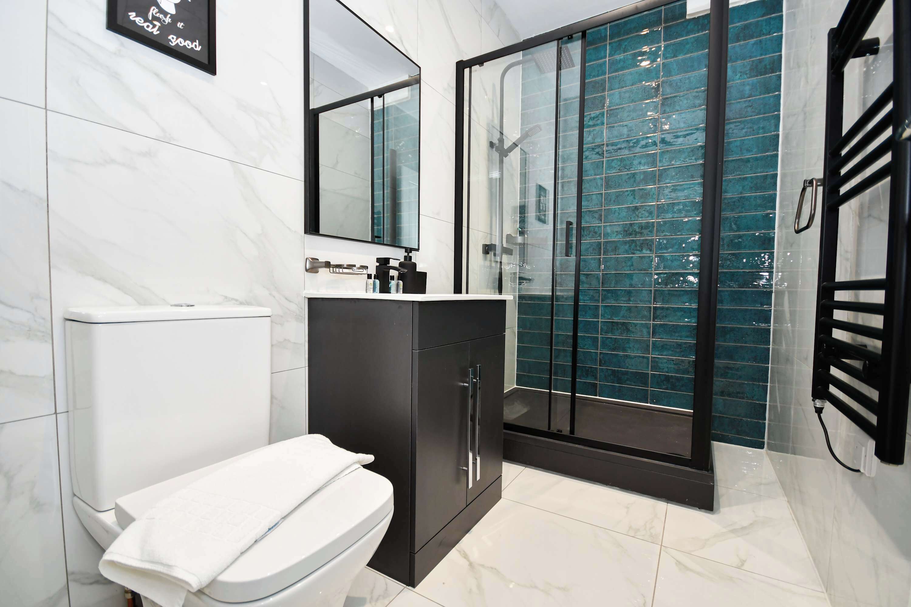 Shower, hair dryer, towels, shampoo