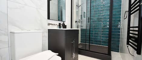 Shower, hair dryer, towels, shampoo