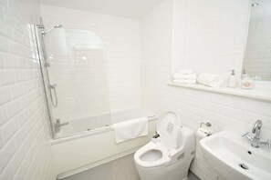Shower, hair dryer, towels, shampoo
