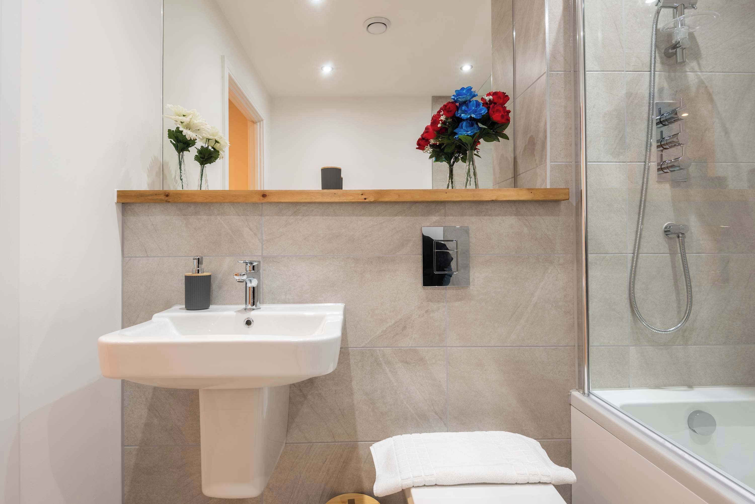 Shower, hair dryer, towels, shampoo
