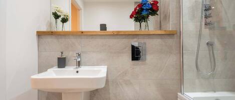 Shower, hair dryer, towels, shampoo