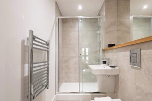 Shower, hair dryer, towels, shampoo