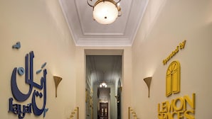 A hotel lobby with marble flooring, a chandelier, and signage for 'Loyalty' and 'Lemon Spaces'. - Boutique Residence Layal-Lemon Spaces (Cairo)