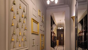 A hallway with marble flooring, framed wall decorations, and a chandelier. - Boutique Residence Layal-Lemon Spaces (Cairo)