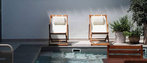 Outdoor pool, open 10:00 AM to 8:00 PM, pool loungers