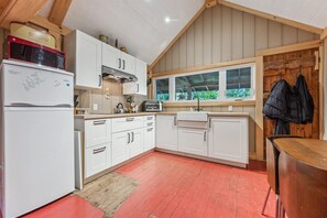 Fridge, coffee/tea maker, cookware/dishes/utensils, dining tables