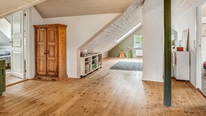 A spacious attic room with wooden floors, a large wooden wardrobe, and a slanted ceiling with skylight. - "Elza" - 2.5km from the sea by Interhome (Fjerritslev)