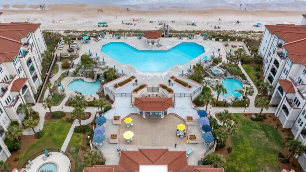 A resort with multiple swimming pools, a central courtyard, and beach access. - Sunny Side Up at Villa Capriani Resort | Unit 108A | North Topsail Beach, NC (North Topsail Beach)