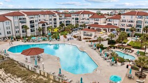 A hotel with multiple swimming pools, outdoor seating areas, and a view of the beach. - Sunny Side Up at Villa Capriani Resort | Unit 108A | North Topsail Beach, NC (North Topsail Beach)