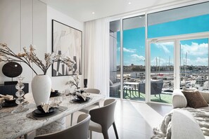 A modern dining area with a large window overlooking a marina.