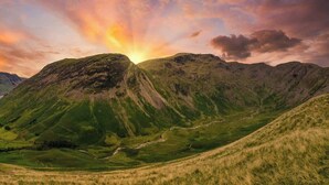 A mountainous landscape with a valley and a winding path. - Elm House Cottage: Charming Country Cottage with Log Burner (High Hesket)