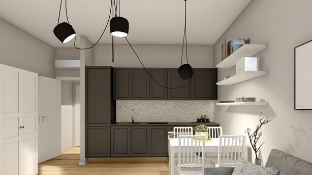 A modern kitchen with dark cabinets, a white countertop, and pendant lighting. There is a dining area with a white table and chairs, and a grey sofa with a patterned pillow. - Studio for 3 guests in Turin (Torino)