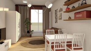 A modern living room with a dining area, a large window, and a view of the sea. - Studio for 3 guests in Turin (Torino)