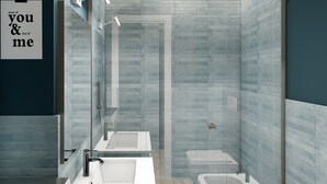 A modern bathroom with a large mirror, two sinks, a shower, and a toilet. - Studio for 3 guests in Turin (Torino)