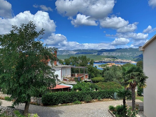 A residential area with a view of a town and mountains in the background.