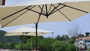 A rooftop terrace with lounge chairs and umbrellas. - Tenuta Nonna Peppa Luxury apartment (Centola)