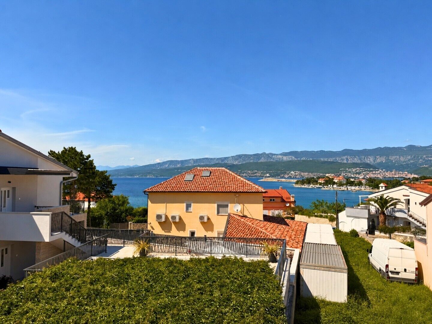 A residential area with a view of the sea and mountains.