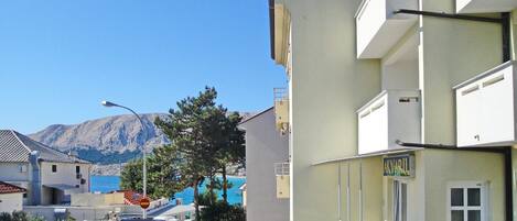 A building with a sign reading "AKVARIL" and a view of mountains in the background.