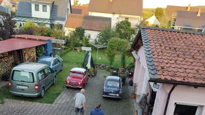 A residential street with parked cars and a person walking. - CORONA and flooding - SAFE due to location and separate entrance (Marktheidenfeld)