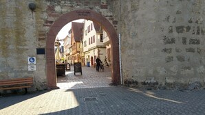 An arched entrance to a historic street with cobblestone pavement, a bench, and a sign indicating a pedestrian zone. - CORONA and flooding - SAFE due to location and separate entrance (Marktheidenfeld)