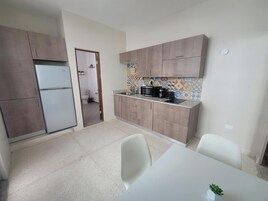 Apartment, 1 Queen Bed | Private kitchen | Coffee/tea maker