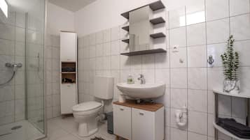 Shower, hair dryer, towels, toilet paper
