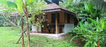 Romantic bungalow in the middle of a tropical garden, close to the beach.