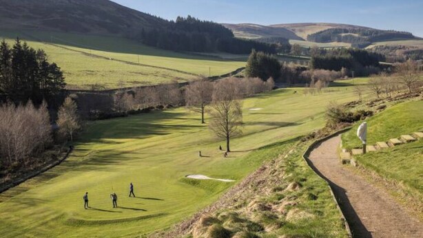 A golf course with a winding path, open grassy areas, and a backdrop of hills and trees. - 1st Floor, One Bed Apt & garden, Scottish Borders (Innerleithen)