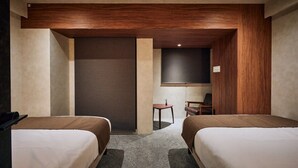 A hotel room with two beds, a small table, a chair, and a TV. - Gold Stage TENJIN (Fukuoka)